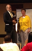 Nan McKay presents CMHA with the 2014 Pioneer in Housing, Honorable Mention.