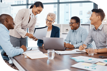 Five professionals gather around a table to share and review documents