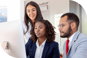 Three professionals read a computer screen