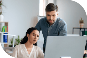 Two professionals reading a computer screen