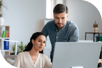 Two professionals read a computer screen