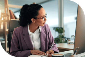 Professional taking notes at a computer