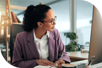 Professional taking notes at a computer
