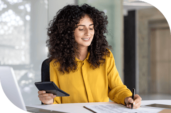 Professional holding a calculator and making notes