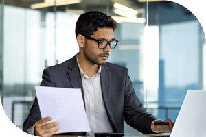 Professional holding paper and checking computer