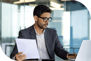 Professional holding paper and checking computer