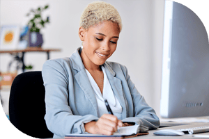 Professional taking notes at a computer