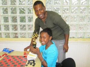 A winning moment at the City of Paterson's Father's Day competitive board game tournament (Photo credit: HUD)