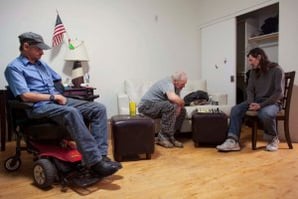 John Hankins, right, who repaired intercontinental ballistic missiles for the Air Force, played chess with William Godwin as Gary Workman watched. All three veterans were considered chronically homeless but are now living in Victory Place, an apartment complex in Phoenix. (Samantha Sais / New York Times)