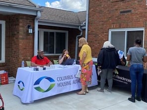 Housing authority staff speak with a resident