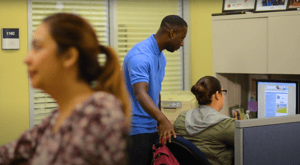 College staff member helps a student at a computer