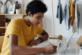 Young man writing at desk